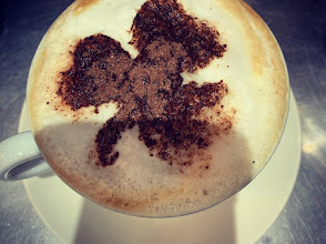 A frothy cappuccino served at Tasty Cafe with cocoa art on top